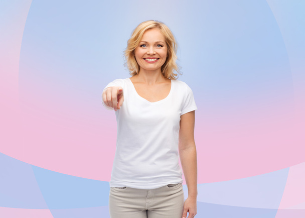 smiling woman in white t-shirt pointing to you - Fotó, kép