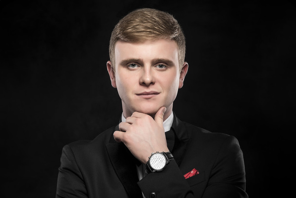 Young handsome man in black suit. - Фото, зображення