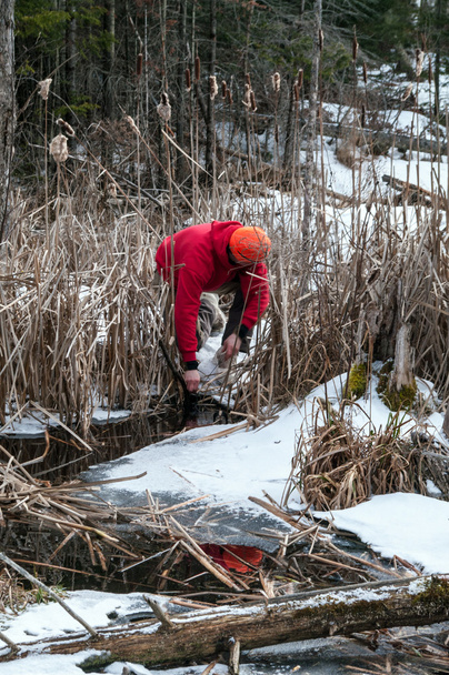Trapper setting a winter water trap - Photo, Image