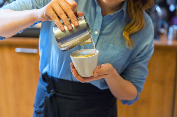 close up of woman making coffee at shop or cafe - Photo, image