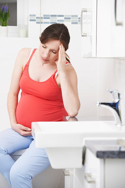 Pregnant Woman Suffering With Morning Sickness In Bathroom - Photo, Image