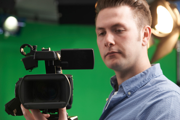 Male Camera Operator In Television Studio - 写真・画像