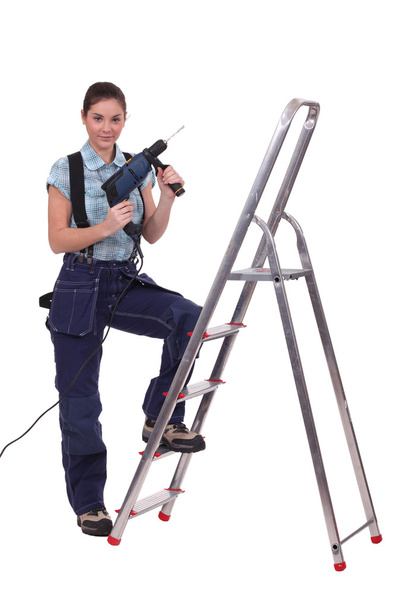 Woman with drill stood on step ladder - Fotoğraf, Görsel