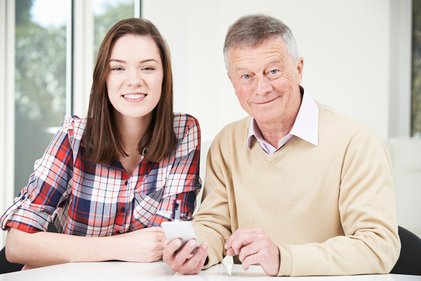 Teenage Granddaughter Showing Grandfather How To Use Mobile Phon - Photo, Image