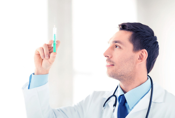 male doctor holding syringe with injection - Foto, Imagem