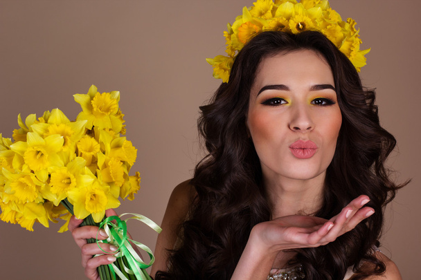 Happy girl with bouquet of yellow daffodil flowers - Photo, image