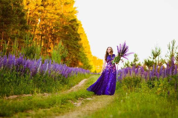girl in a field of purple wildflowers - Φωτογραφία, εικόνα