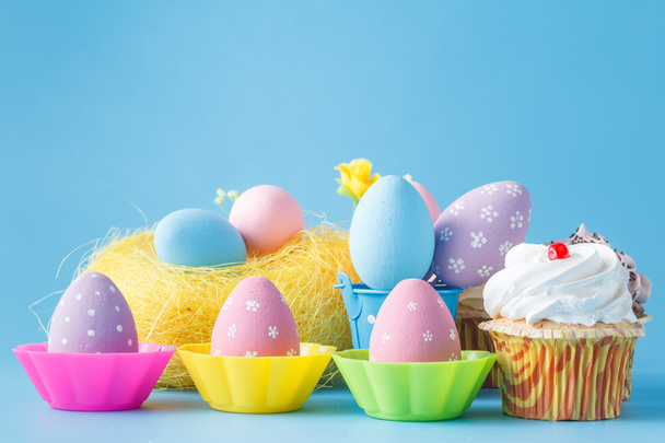 decoration with easter eggs nest on blue background - Fotó, kép
