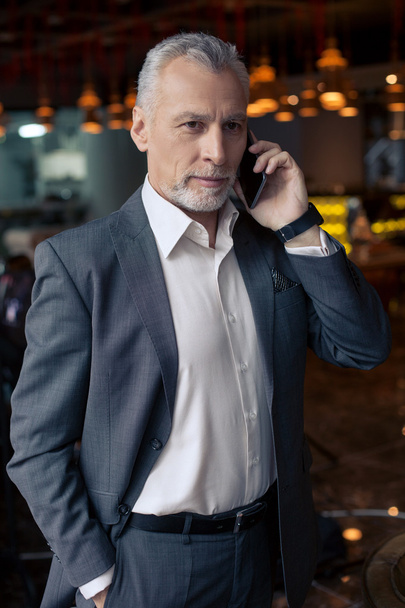Mature male worker is using a telephone - Foto, Imagem