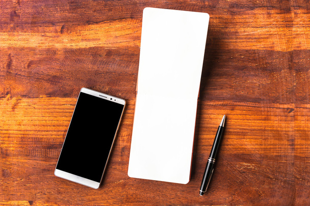 Blank paper with pen and smartphone on wood table concept and Id - Photo, image