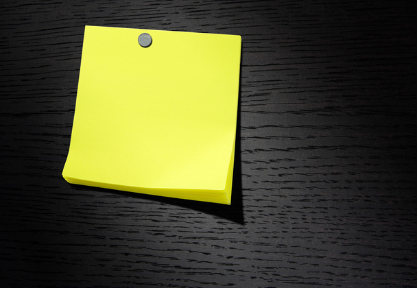 Yellow note paper on dark wood background - Photo, Image