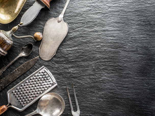 Kitchen utensils on the graphite background. - Zdjęcie, obraz