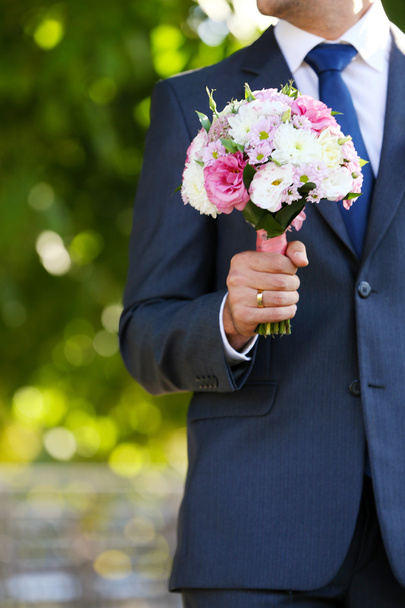 Groom holding wedding bouquet   - Photo, Image