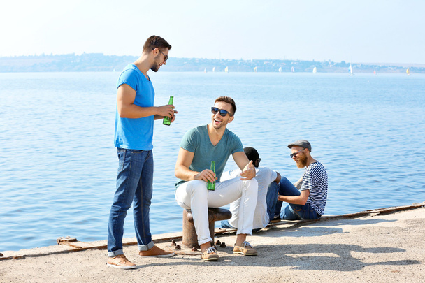 men talking on the riverside - Foto, imagen