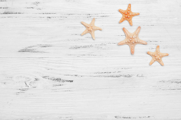 Seashells on wooden table - Фото, зображення