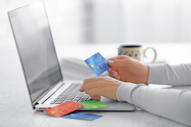 E-commerce concept. Woman with credit card, laptop and cup of coffee, close up - Valokuva, kuva