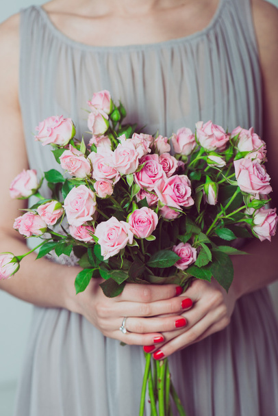 Close up image of bridesmaid with a bouquet of wedding flowers - Fotó, kép