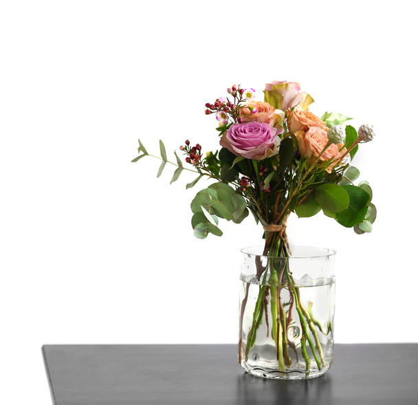 Jar of roses on table - Foto, afbeelding