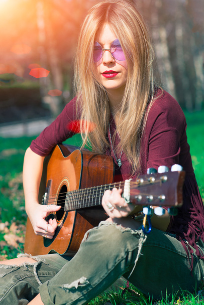 Girl with blond hair playing guitar - Photo, Image