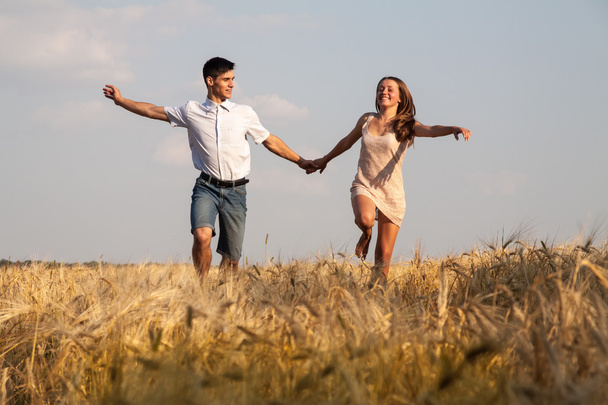 Young couple walking through  wheat field - Photo, Image