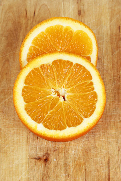 Orance slices on wooden chopping - Fotó, kép