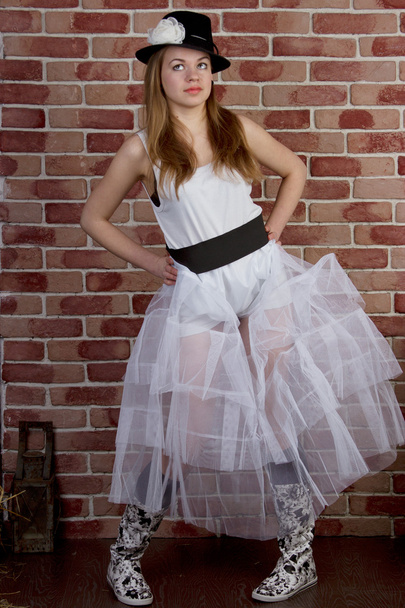 Fashionable young woman posing of a brick wall. - Photo, image