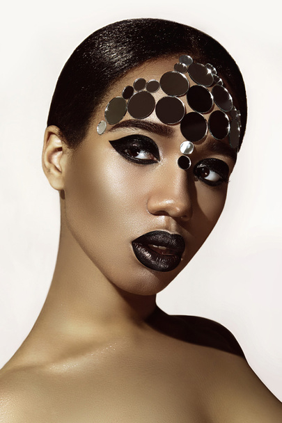 Negress. Mirror round ornament on her face. Ethnic beauty. - Фото, изображение