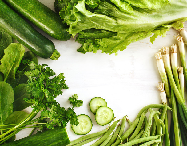 Green vegetables on wooden background - Фото, изображение