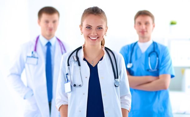 Attractive female doctor in front of medical group - Φωτογραφία, εικόνα