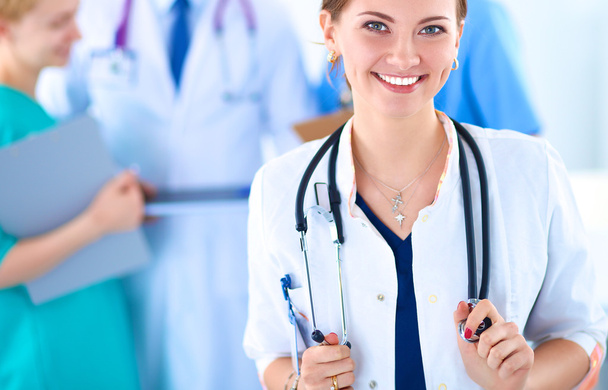 Attractive female doctor in front of medical group - Photo, image