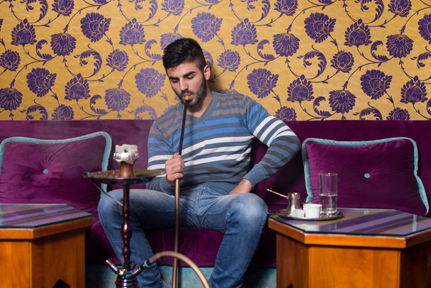 Man Smoking Shisha At Arabic Restaurant - 写真・画像