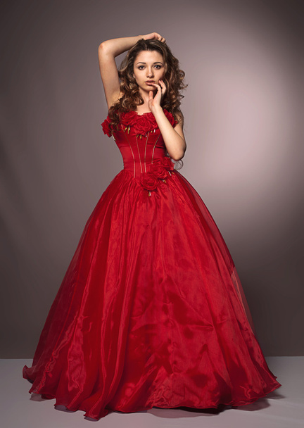 Beautiful long haired woman in red dress - Fotoğraf, Görsel