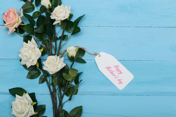 Mothers day card and  beautiful roses on blue wooden background - Foto, Imagem