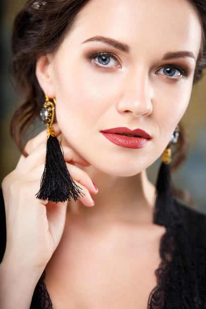 Elegant young woman with perfect makeup and hair style in a black dress with diadem and earrings. Beauty fashion portrait with accessories - Zdjęcie, obraz