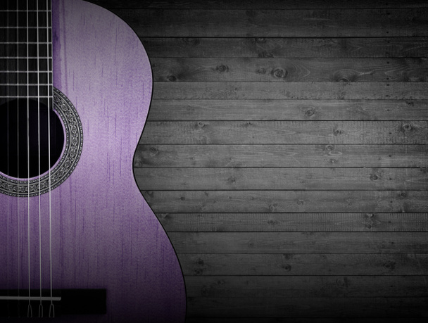 Parte de una guitarra acústica rosa sobre un fondo de madera gris
. - Foto, Imagen