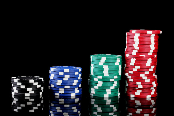 Casino chips isolated on black - 写真・画像