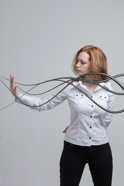 Woman with electrical cables or wires, curved lines - Foto, afbeelding