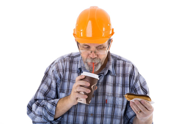 A senior man builder has a lunch with coffee and cake - Photo, Image