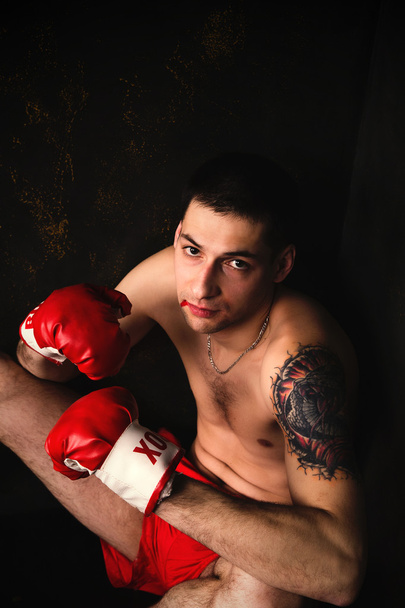 Boxer s červenými rukavice v temné místnosti - Fotografie, Obrázek
