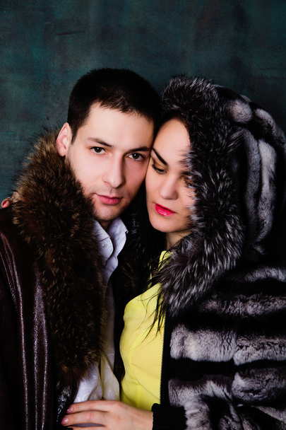 Young beautiful couple of brunette woman and handsome man in fur - Photo, Image
