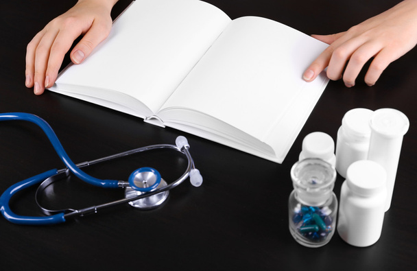 medical book with pills and blue stethoscope - Foto, Imagem