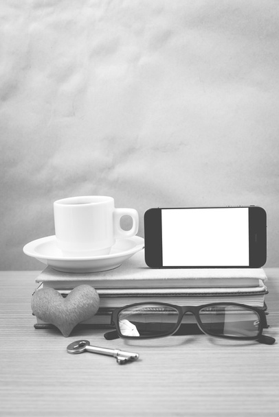 office desk : coffee and phone with key,eyeglasses,stack of book - Foto, imagen