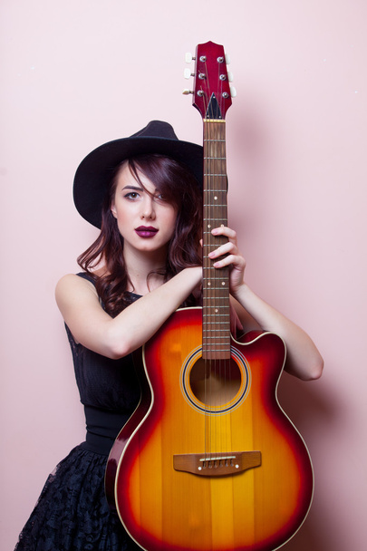 portrait of a young beautiful woman with guitar - Photo, image