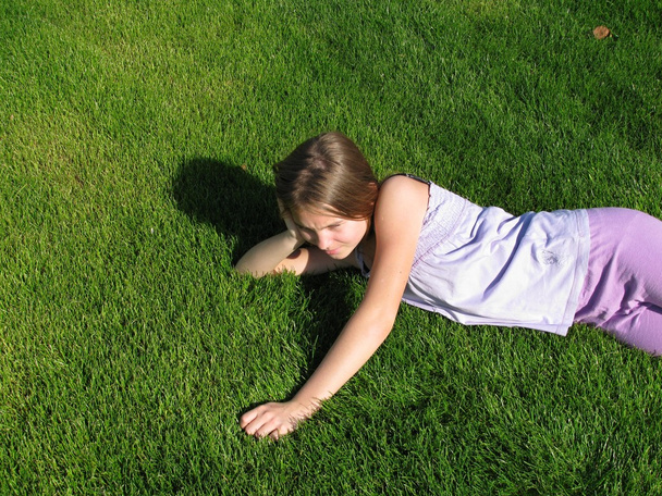 Chica joven acostada en la hierba
 - Foto, imagen