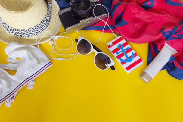 Diversi oggetti per viaggiare su sfondo giallo
 - Foto, immagini