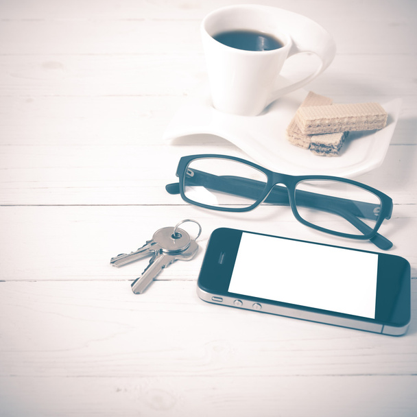 coffee cup with wafer,phone,key,eyeglasses vintage style - Фото, изображение