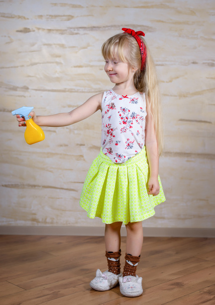 Cute girl using spray bottle - Foto, imagen