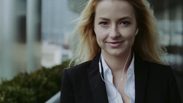 Pretty Young Business Woman Talking by Phone Against Complex of Modern Office Buildings. - Záběry, video