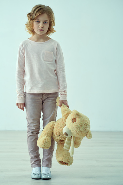 Sad little girl standing with bear - Valokuva, kuva