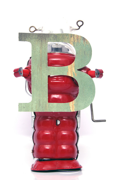 robot  holding up letters on white - Photo, Image